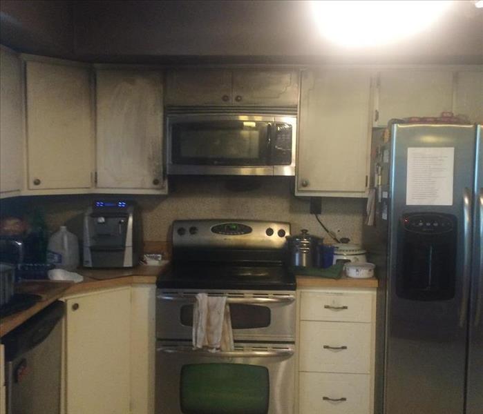 Picture of a fire damaged kitchen cabinets and stove in a Scranton home